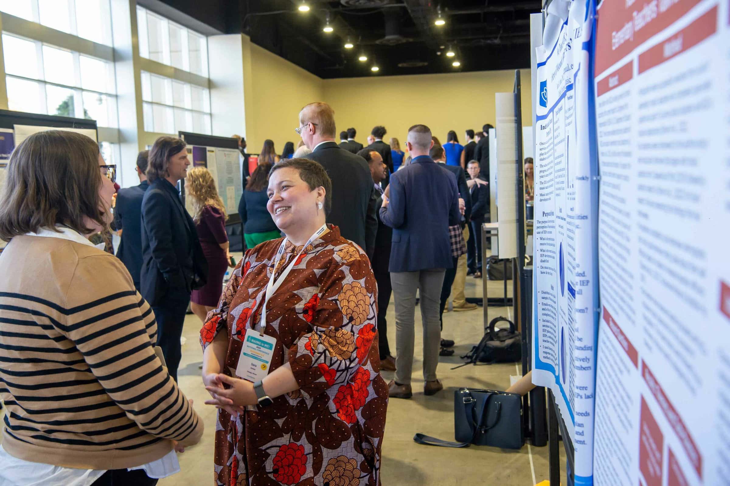 music research poster presentation setting with women in conversation