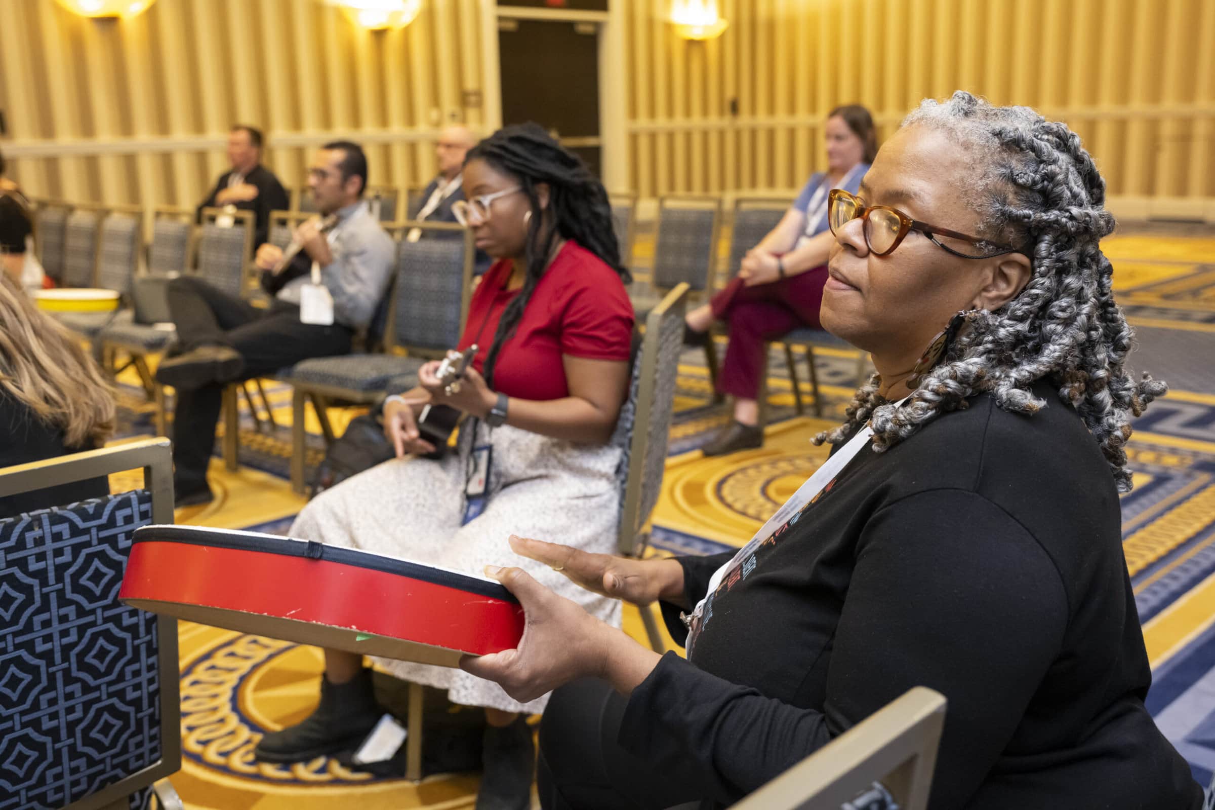 general music 2022 conference session with educator holding percussion instrument and other educators in background holding ukuleles