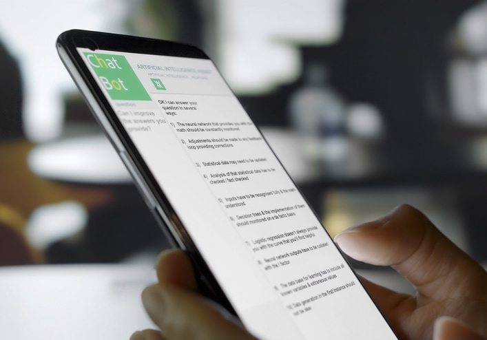 Chat AI concept on smart phone held by a woman's hand