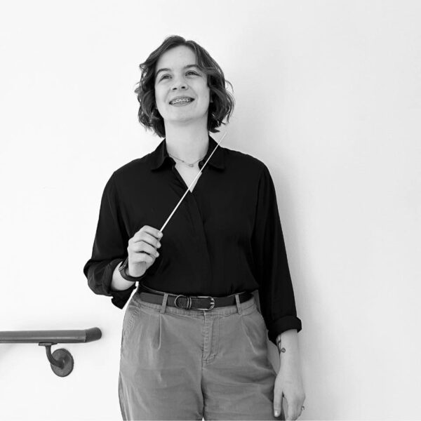 Tori Condra with conductor baton black and white headshot
