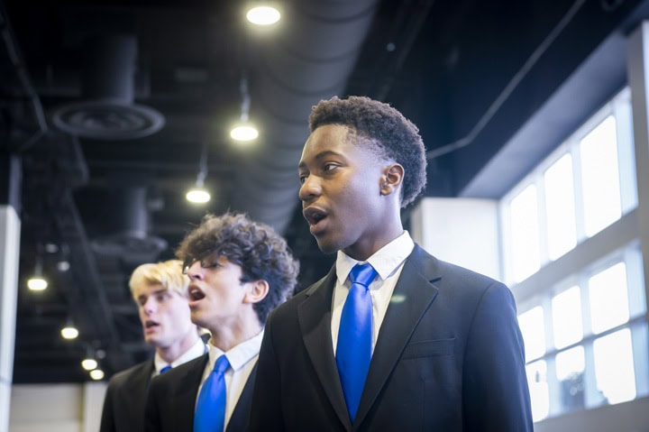 male high school choral students singing